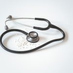 black and silver stethoscope on white surface